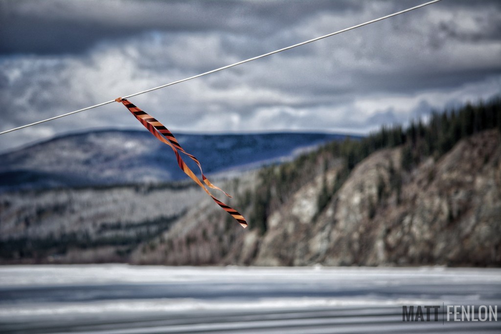 This rope is attached to the yellow tripod on the ice, and is part of the annual "Break Up" event. When the tripod moves, ice on the Yukon River at Dawson has officially broken up.